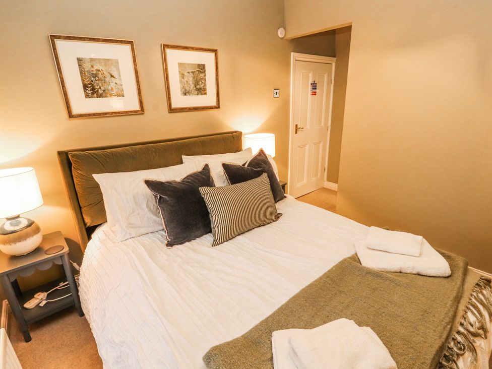 A bedroom with a bed and bedside table at Deer How Farm Patterdale near Glenridding