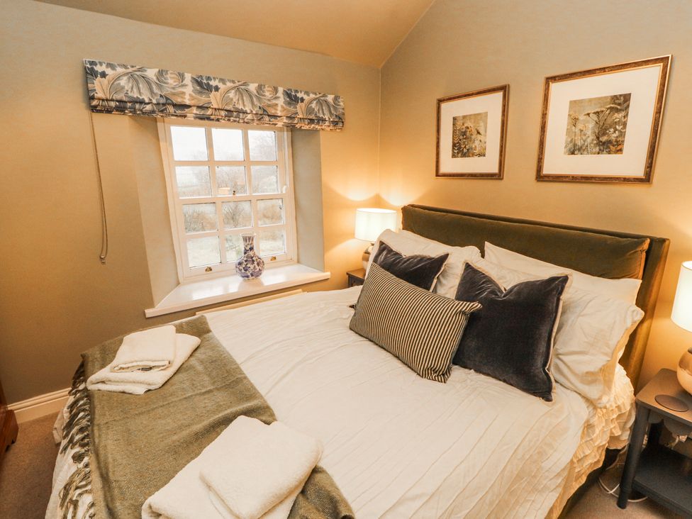 A bedroom with a bed and window at Deer How Farm Patterdale near Glenridding