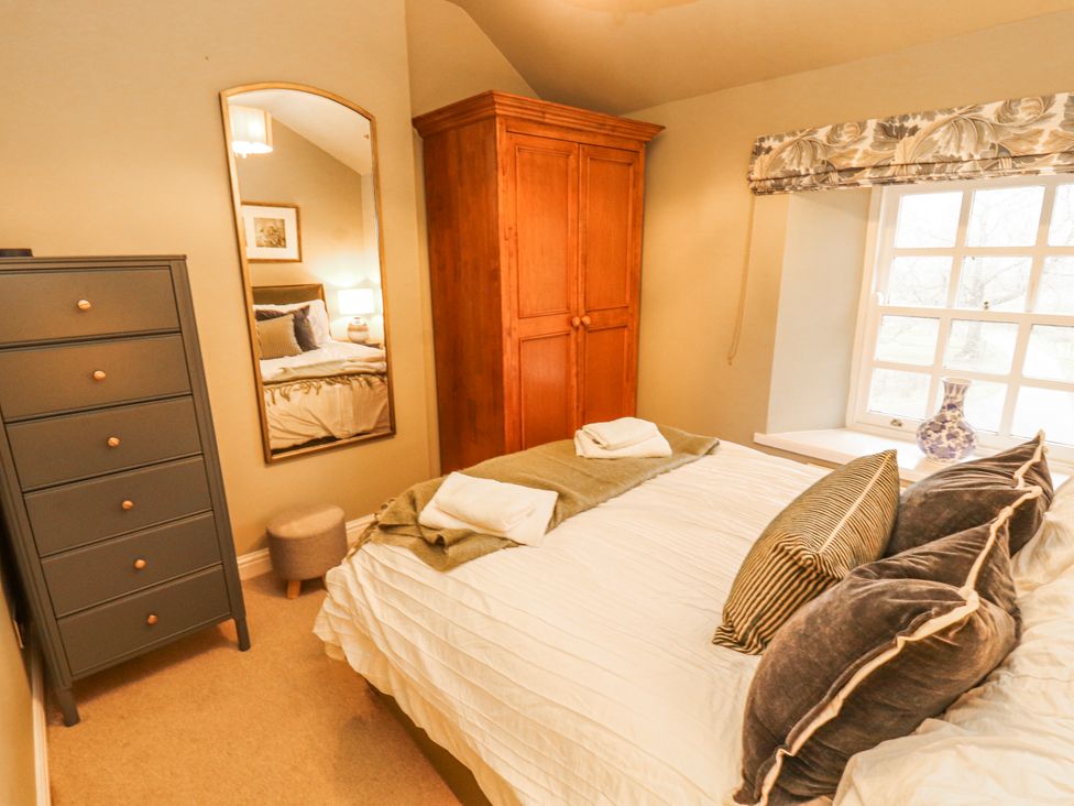 A bedroom with a bed and wardrobe at Deer How Farm Patterdale near Glenridding
