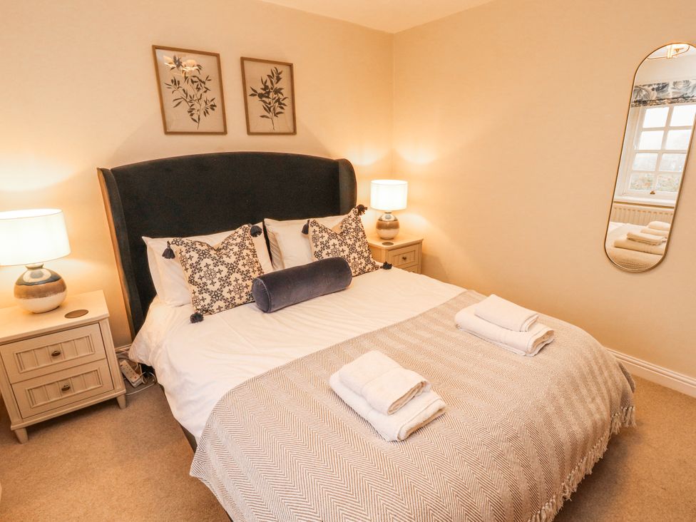 A bedroom with a bed and nightstands at Deer How Farm in Patterdale near Glenridding