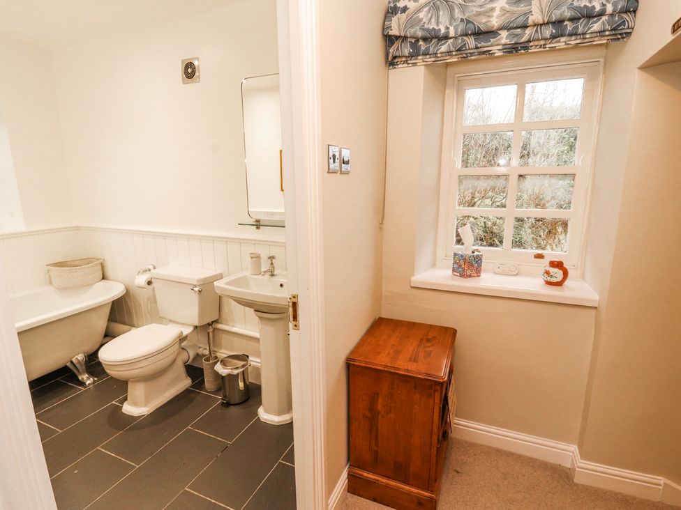 A bathroom with a bathtub, toilet, and sink at Deer How Farm, Patterdale near Glenridding