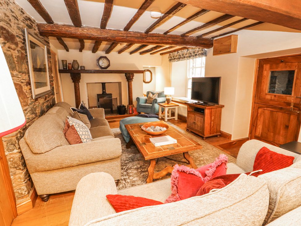 A living room with a coffee table and television at Deer How Farm, Patterdale near Glenridding