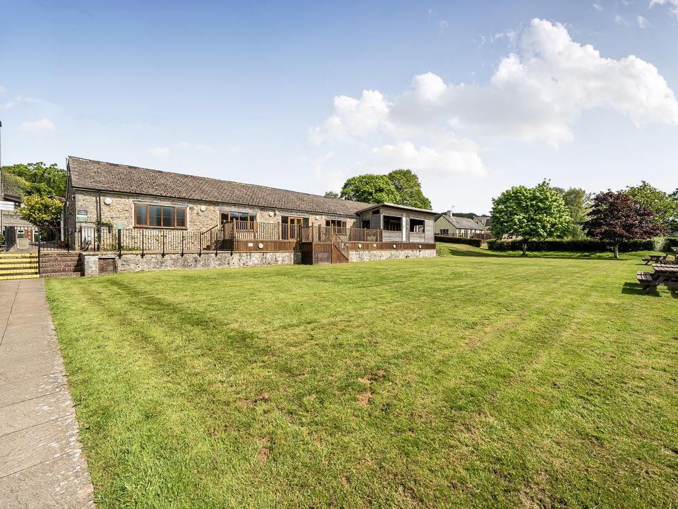 A building with decking and grass area at Harcombe House Accessible Pet Free Bungalow Sleeps 6 in Chudleigh