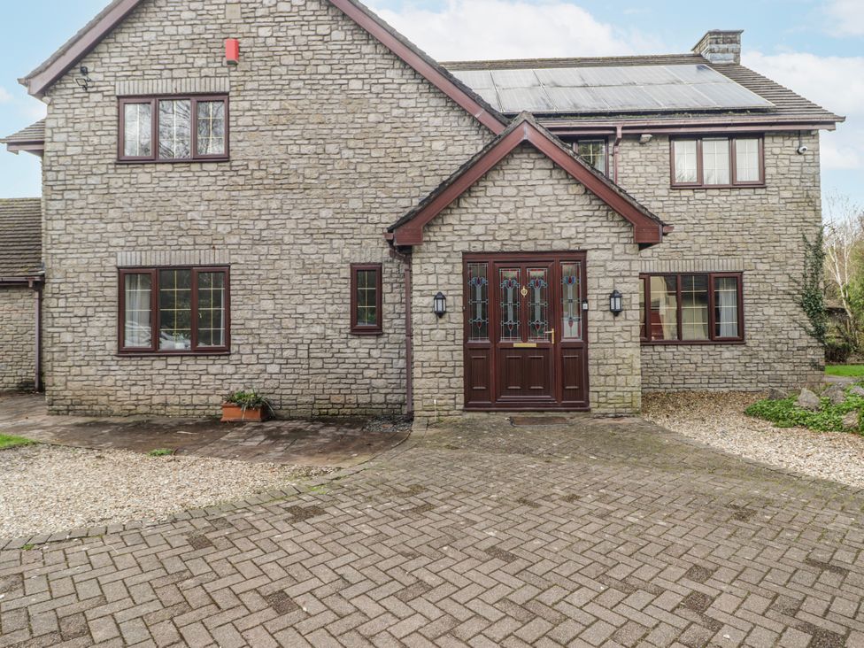 A house with a stone exterior and front door at Carreg Llwyd in Groeswen near Trecenydd