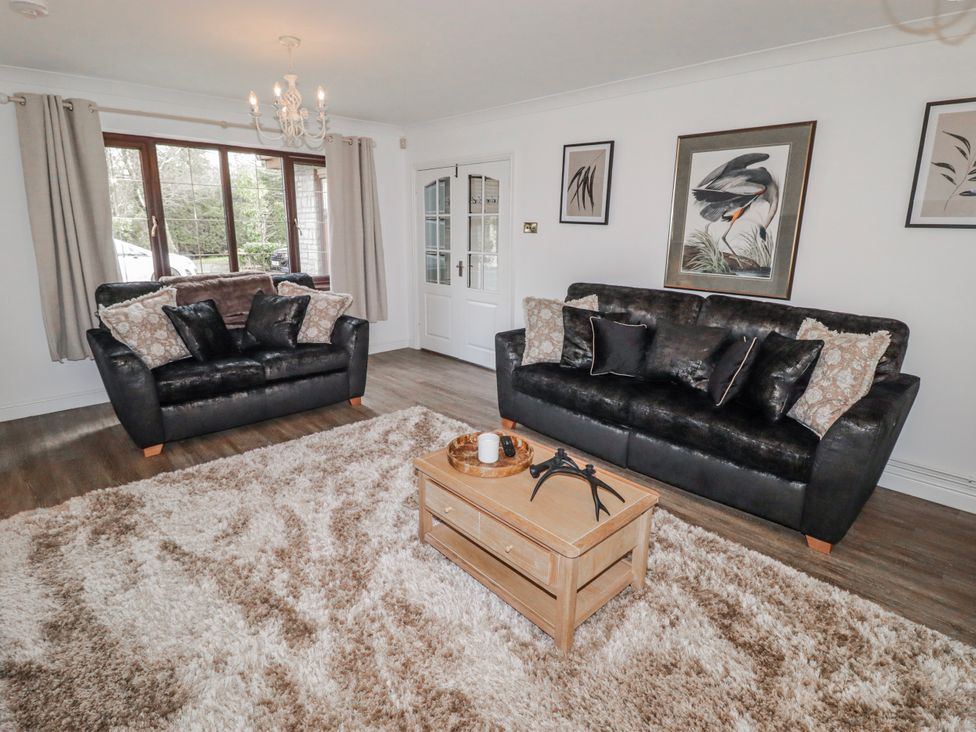 A living room with sofas and a coffee table at Carreg Llwyd Groeswen near Trecenydd