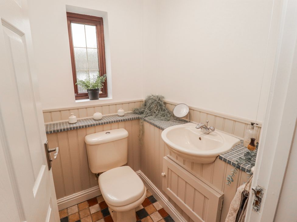 A bathroom with a toilet and sink at Carreg Llwyd in Groeswen near Trecenydd