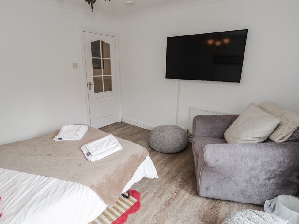 A bedroom with a bed and television at Carreg Llwyd in Groeswen near Trecenydd