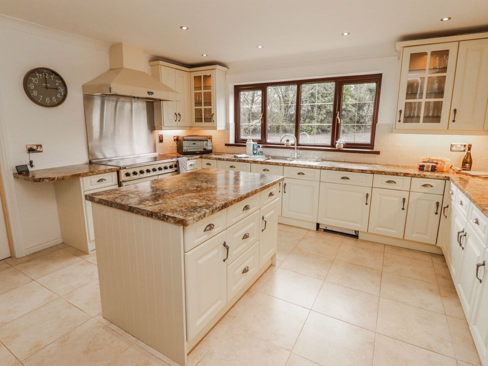 A kitchen with a countertop and an oven at Carreg Llwyd in Groeswen near Trecenydd