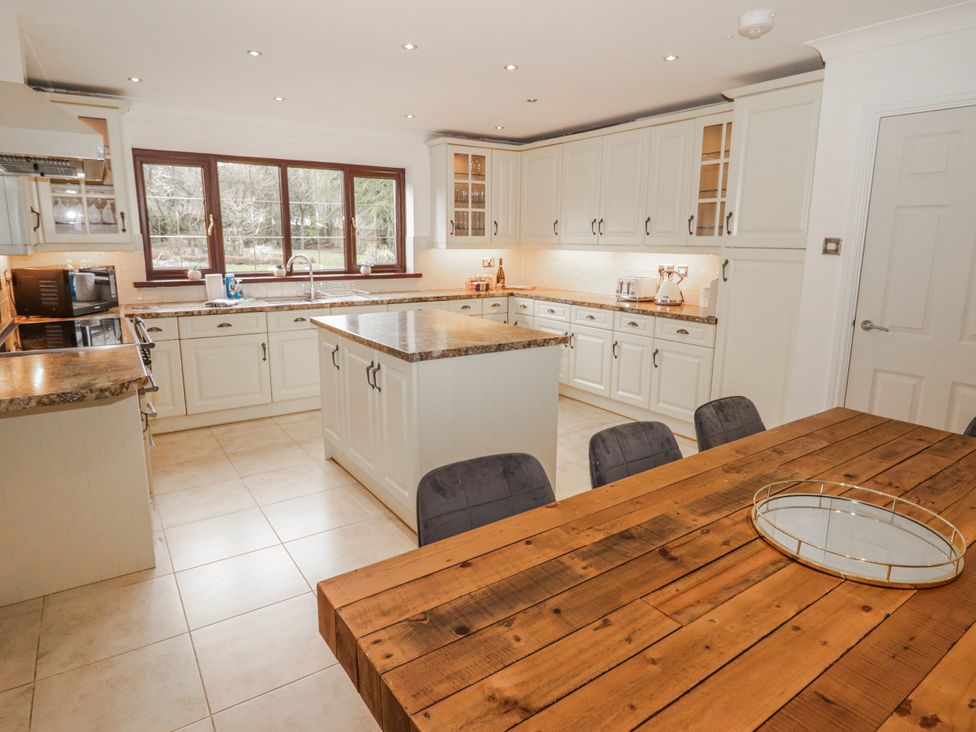A kitchen with a dining table at Carreg Llwyd near Groeswen Trecenydd
