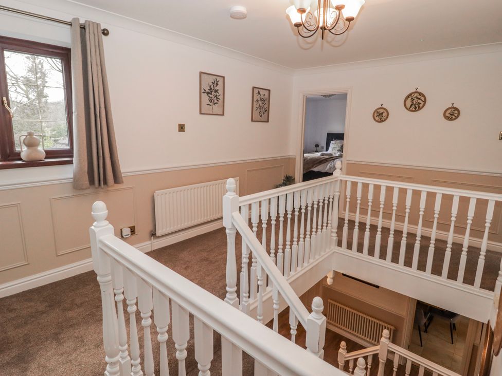 A landing with staircase and artwork at Carreg Llwyd in Groeswen near Trecenydd