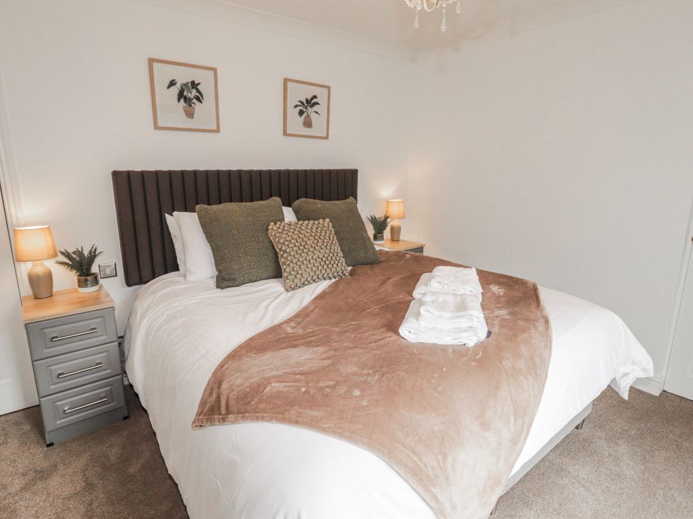 A bedroom with a bed and bedside tables at Carreg Llwyd near Groeswen Trecenydd
