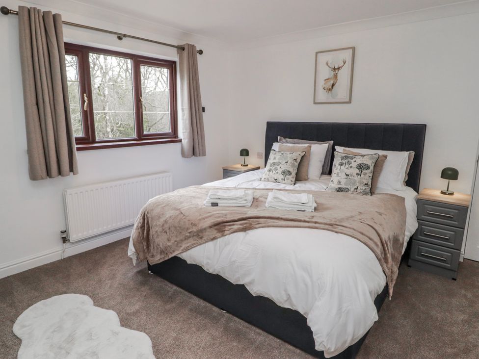 A bedroom with a bed and bedside tables at Carreg Llwyd near Groeswen Trecenydd
