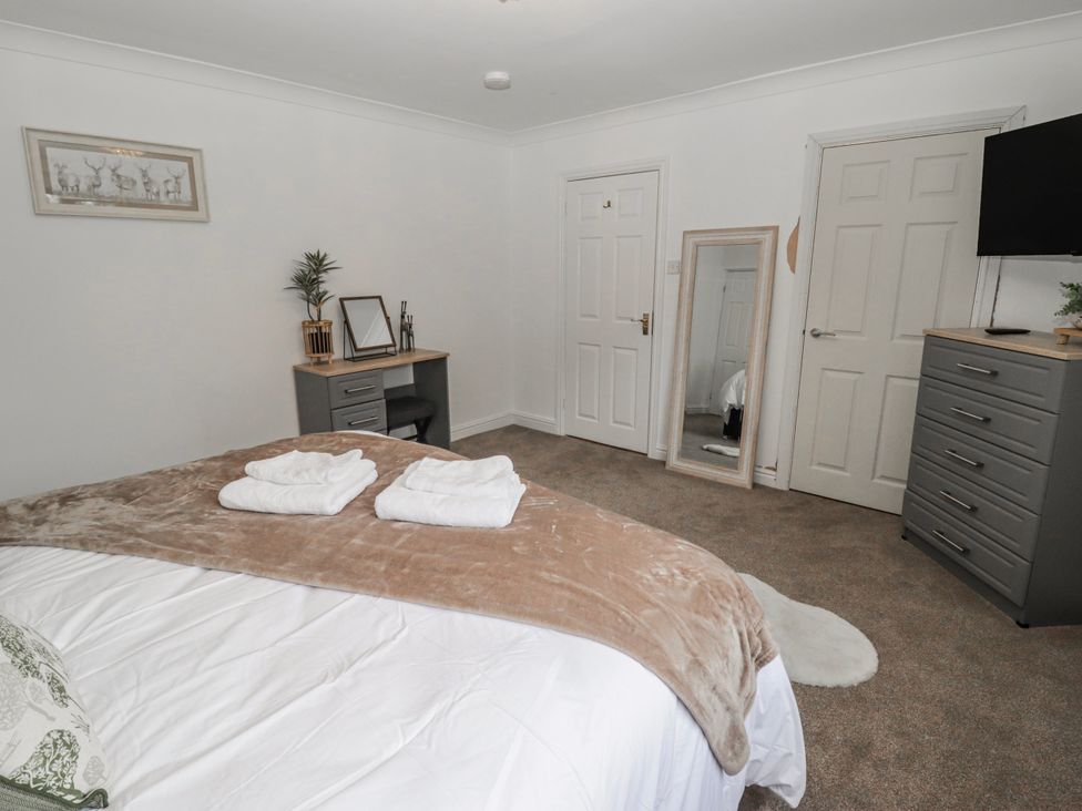 A bedroom with a bed and dresser at Carreg Llwyd Groeswen near Trecenydd