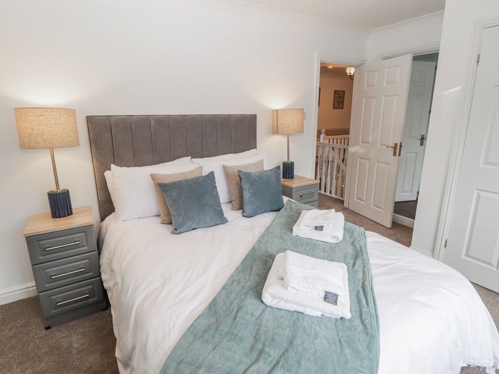 A bedroom with a bed and bedside table at Carreg Llwyd in Groeswen near Trecenydd