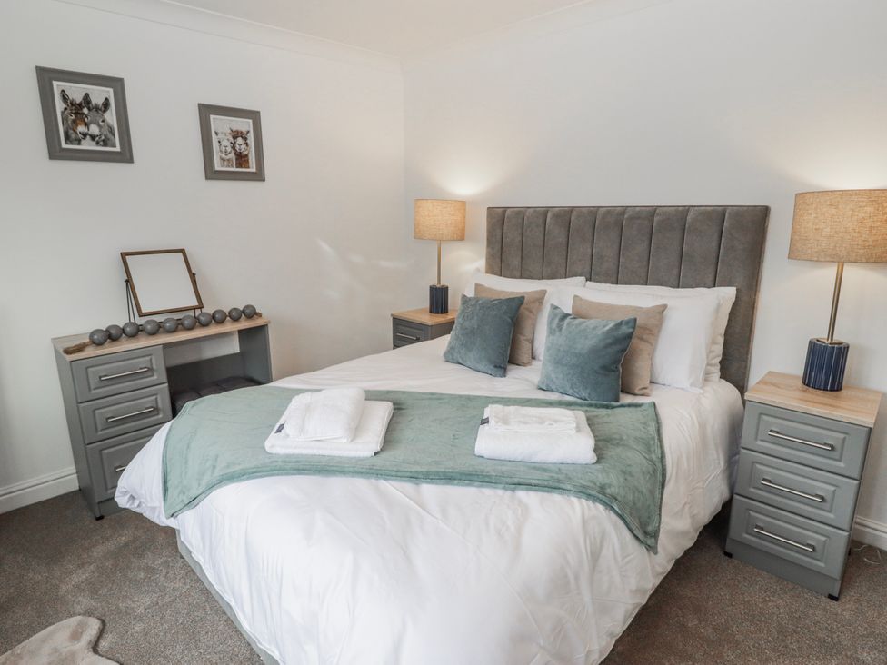 A bedroom with a bed and bedside tables at Carreg Llwyd in Groeswen near Trecenydd