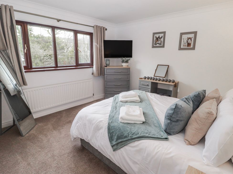 A bedroom with a bed and television at Carreg Llwyd Groeswen near Trecenydd