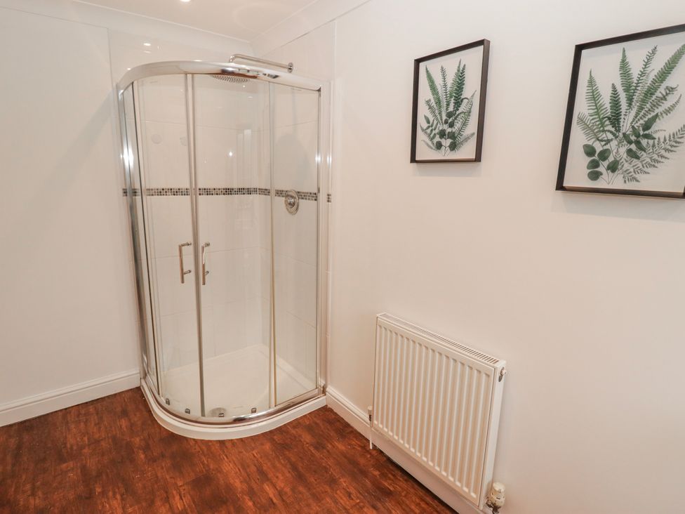 A shower and radiator in a bathroom at Carreg Llwyd Groeswen near Trecenydd