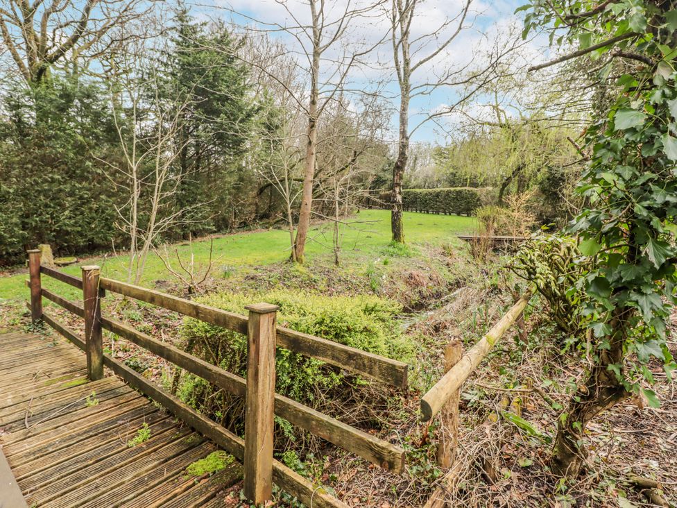 An outdoor area with a wooden fence and grass at Carreg Llwyd in Groeswen near Trecenydd