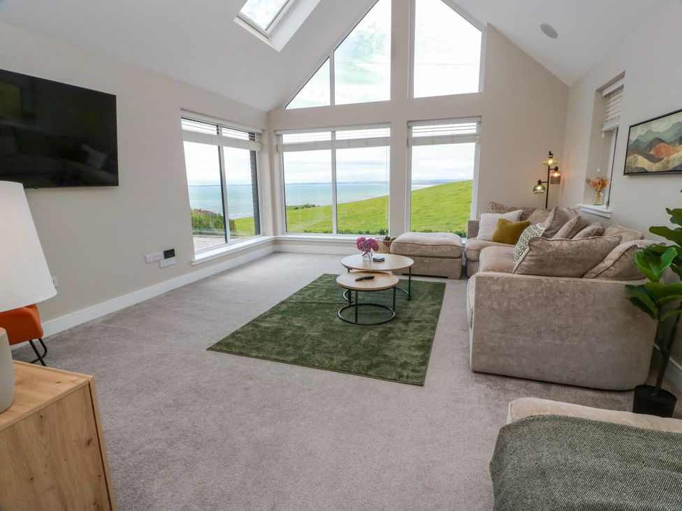 A living room with a sofa and coffee table at Balcarry Barn in Glenluce