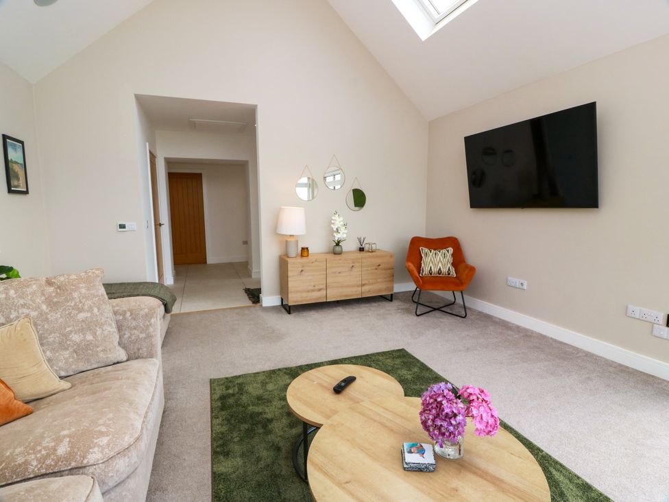 A living room with sofa and coffee table at Balcarry Barn in Glenluce