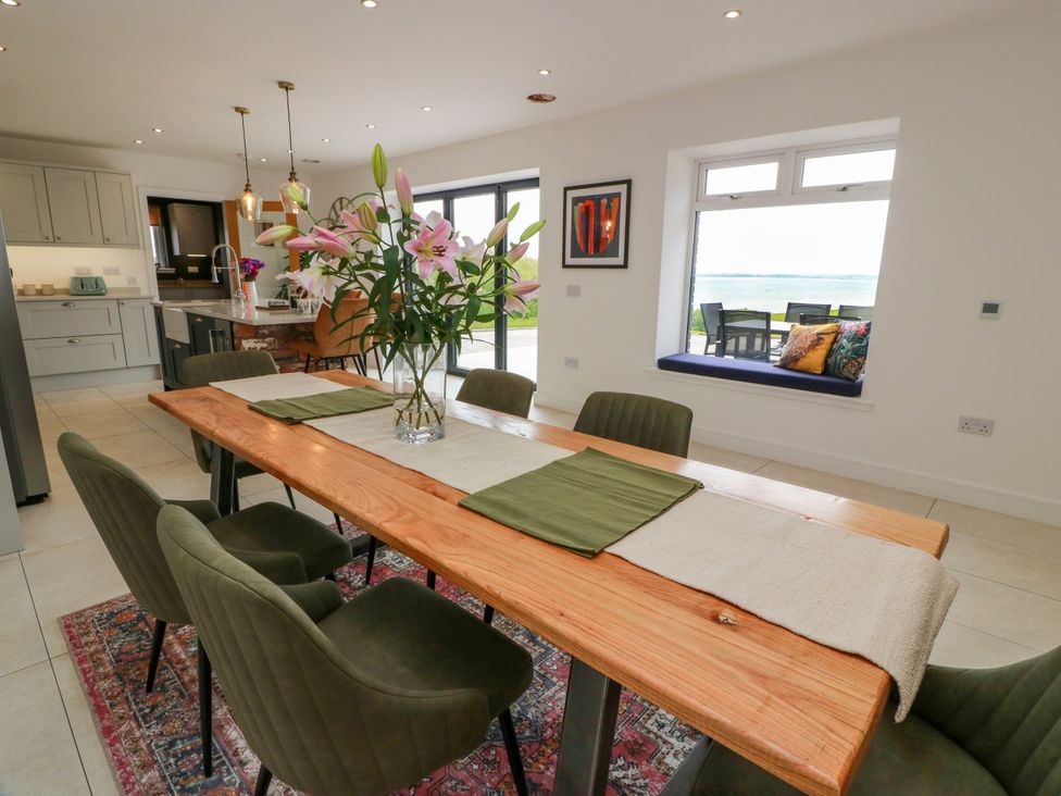 A dining area with a table and chairs at Balcarry Barn in Glenluce