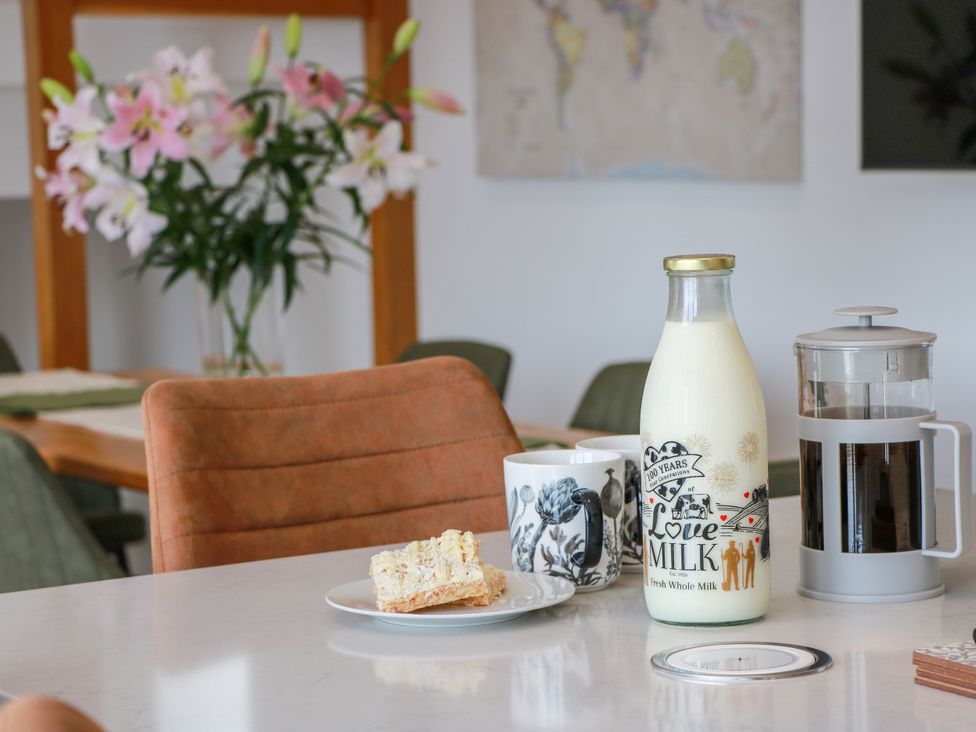 A kitchen with a bottle of milk and coffee on a table at Balcarry Barn Glenluce