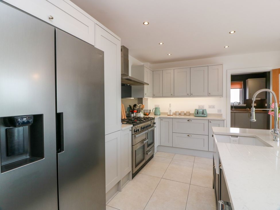 A kitchen with appliances and cabinets at Balcarry Barn in Glenluce