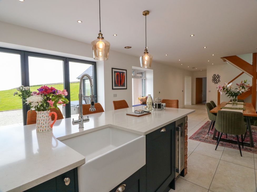 A kitchen with a sink and island at Balcarry Barn in Glenluce