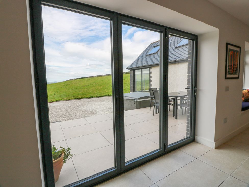 A view of sliding doors leading to an outdoor patio area at Balcarry Barn Glenluce
