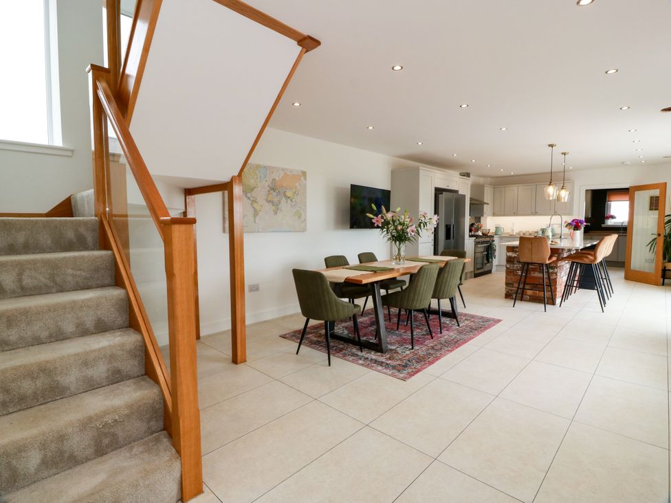 A dining room with a table and chairs at Balcarry Barn Glenluce