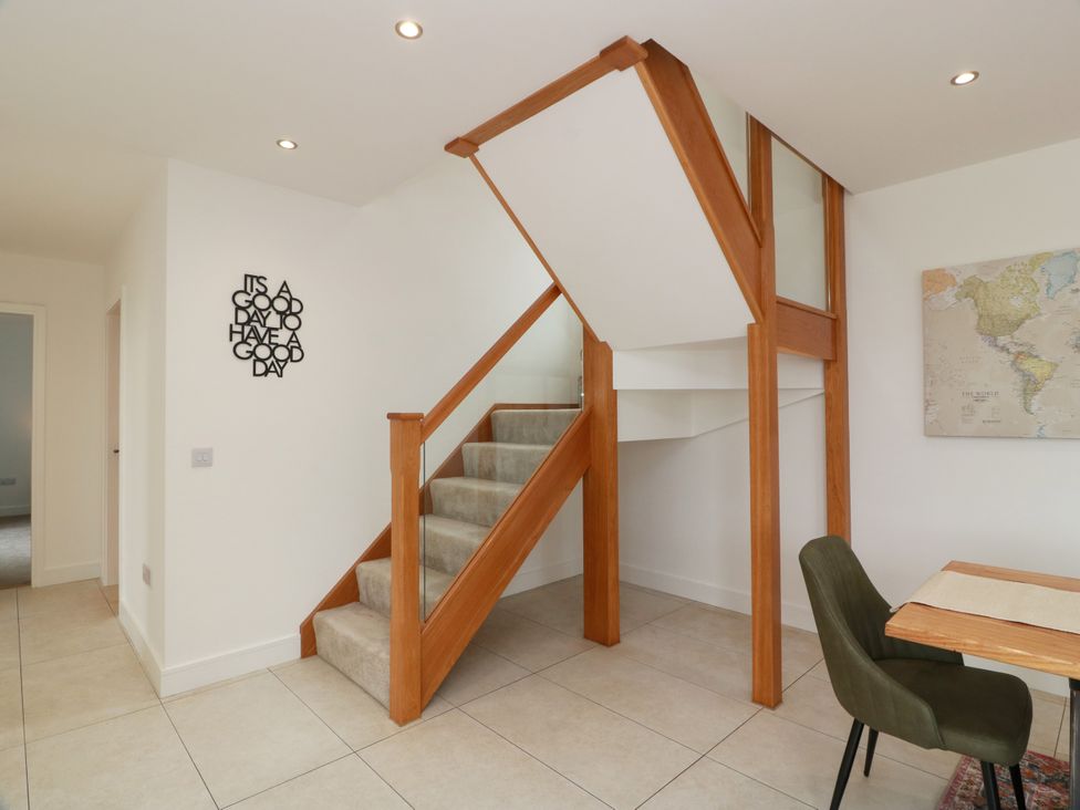A staircase with a table and chair at Balcarry Barn in Glenluce
