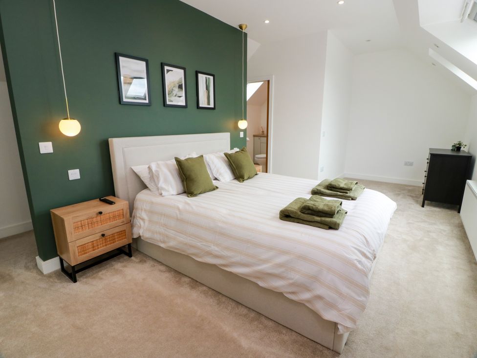 A bedroom with a bed and bedside table at Balcarry Barn in Glenluce