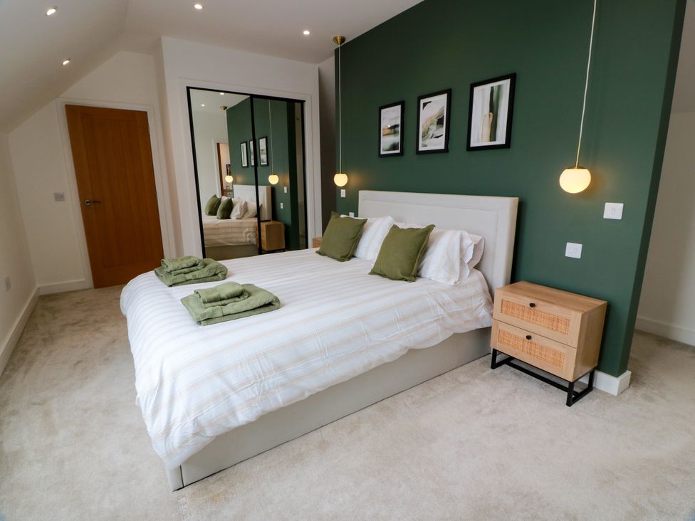 A bedroom with a bed and bedside table at Balcarry Barn in Glenluce