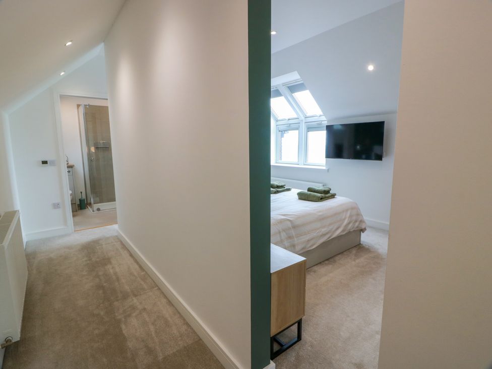 A bedroom with a bed and television at Balcarry Barn in Glenluce