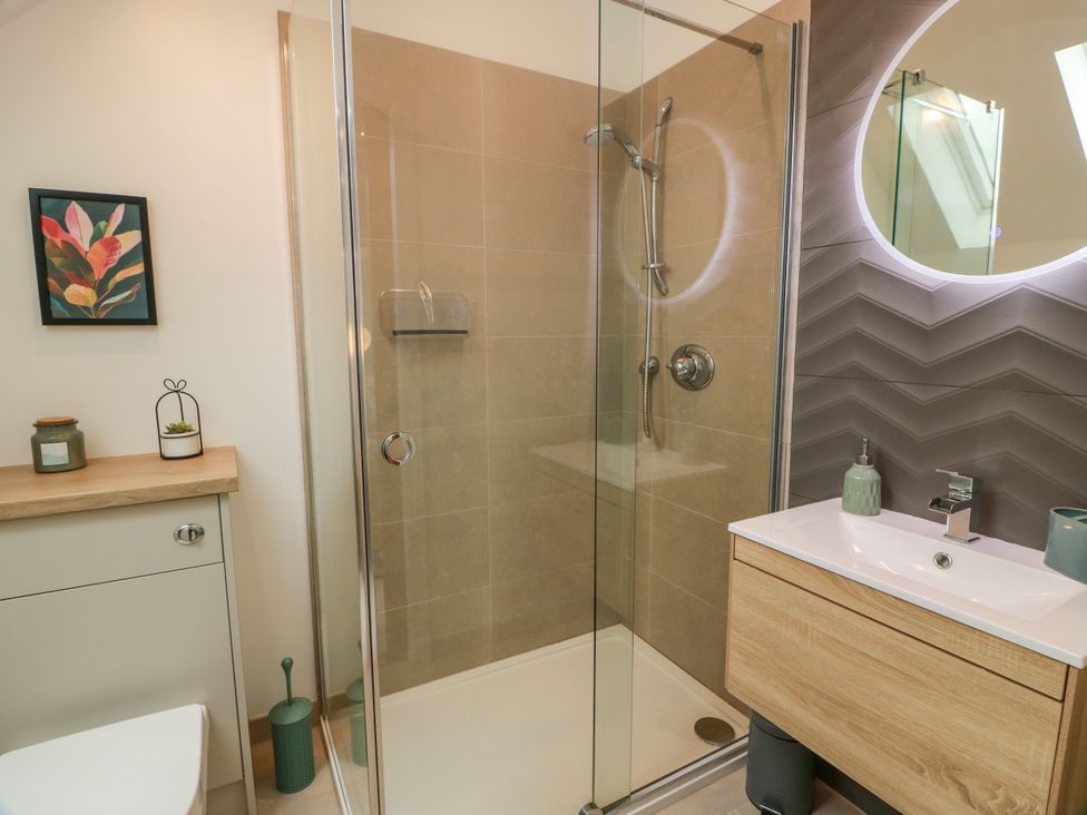 A bathroom with a shower and sink at Balcarry Barn in Glenluce