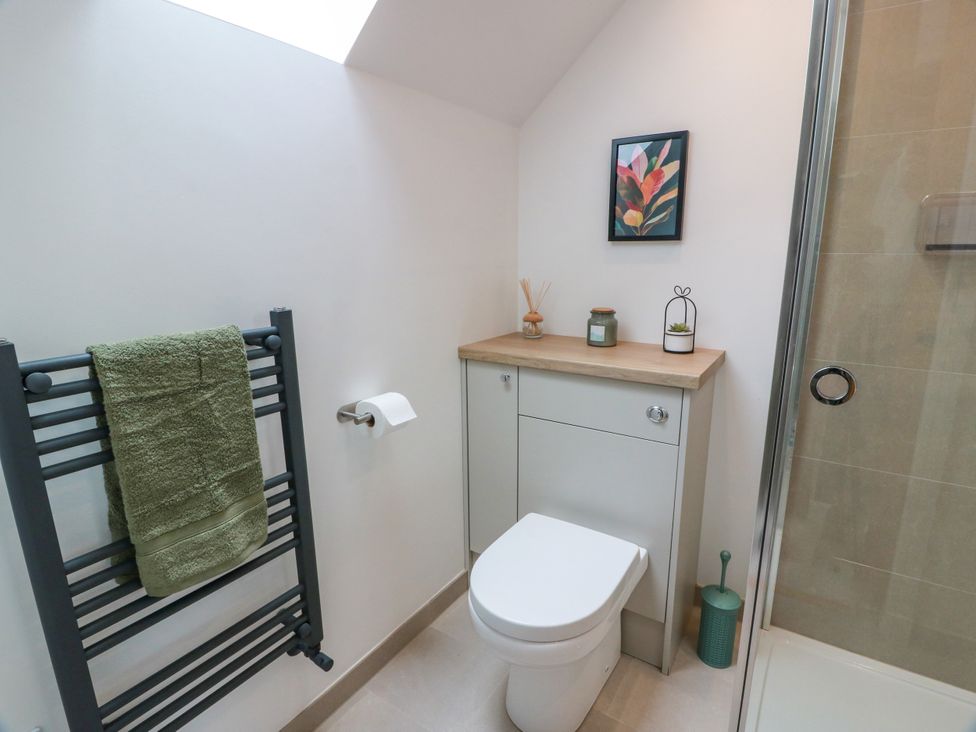 A bathroom featuring a toilet, sink, and shower at Balcarry Barn in Glenluce