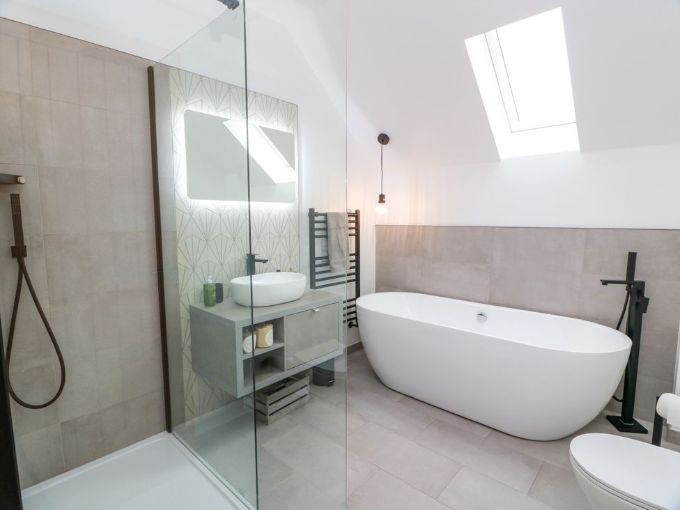 A bathroom with a bathtub and shower at Balcarry Barn in Glenluce
