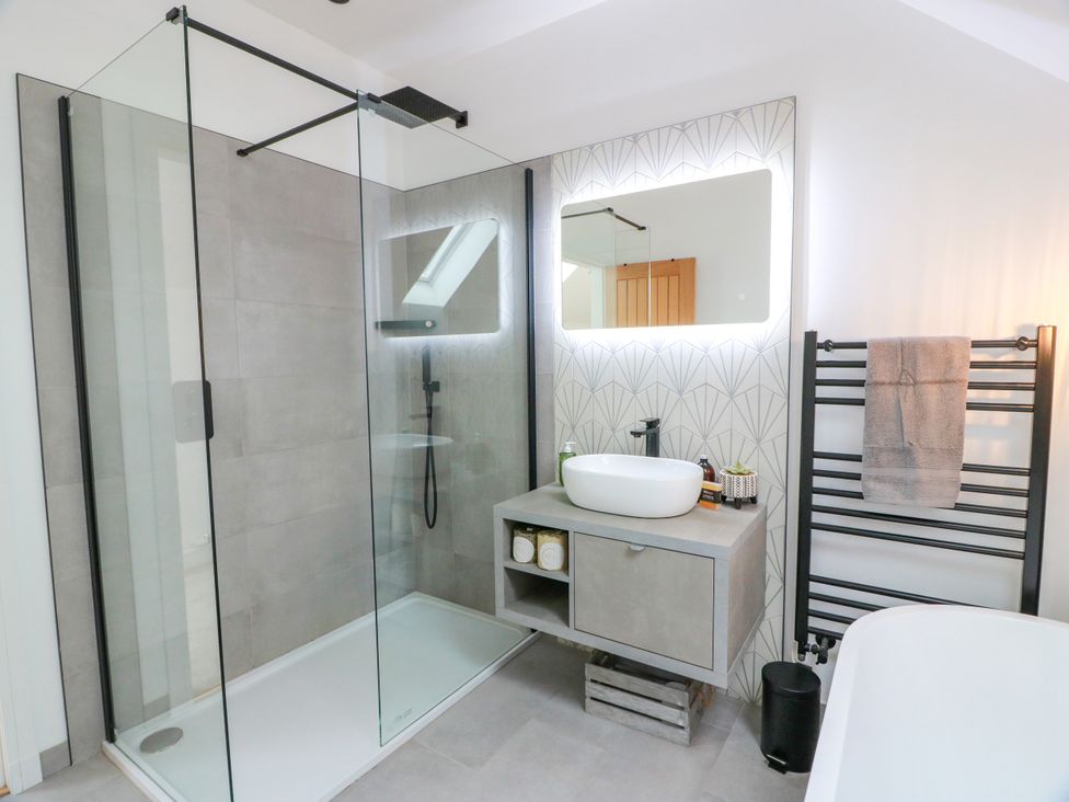 A bathroom with a shower and sink at Balcarry Barn in Glenluce