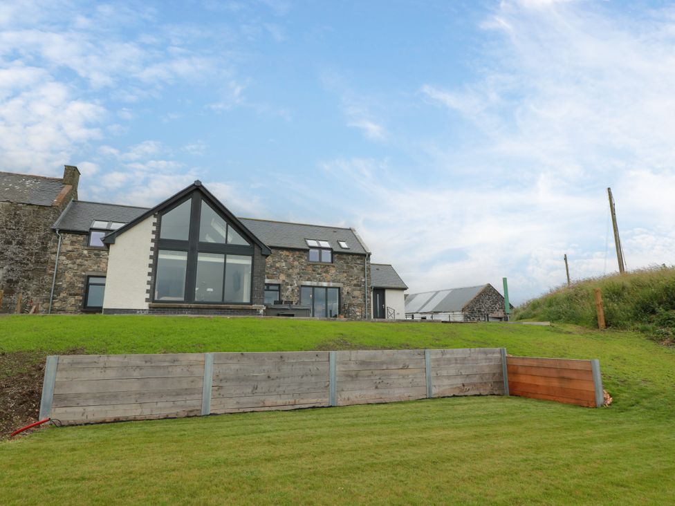 A view of a house with grass and a fence at Balcarry Barn in Glenluce