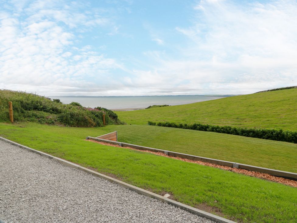 A view of the sea and grassy landscape at Balcarry Barn in Glenluce
