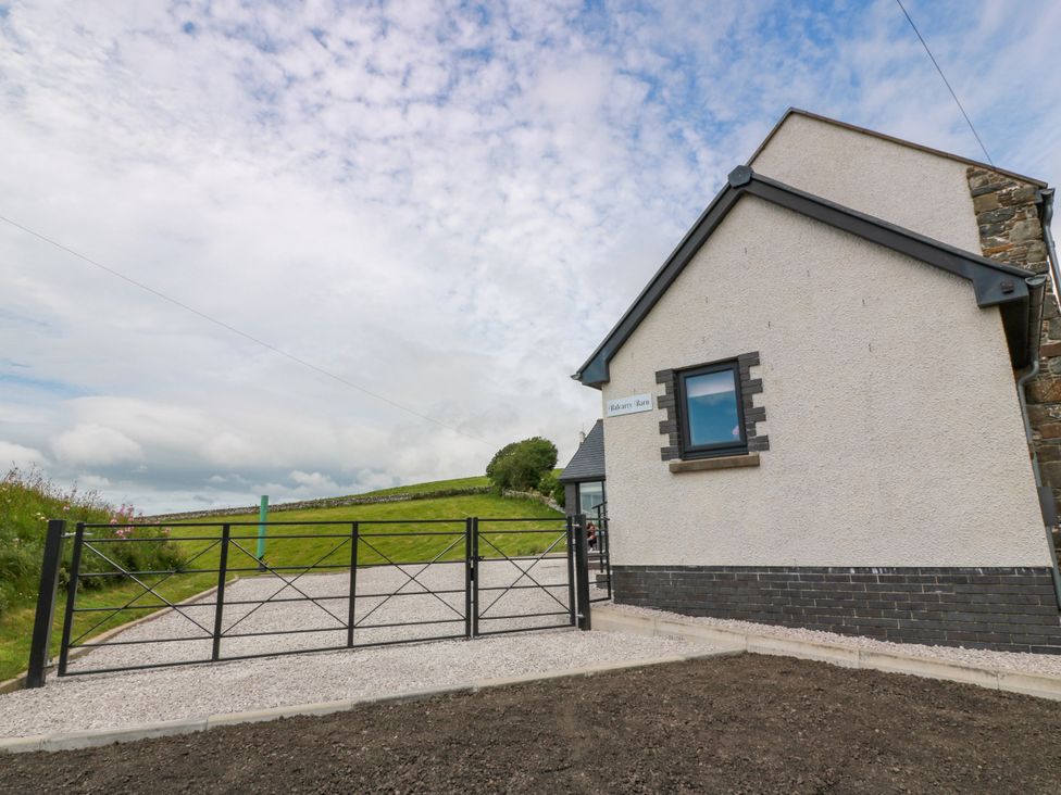 An outdoor view of a house entrance with a gate at Balcarry Barn in Glenluce