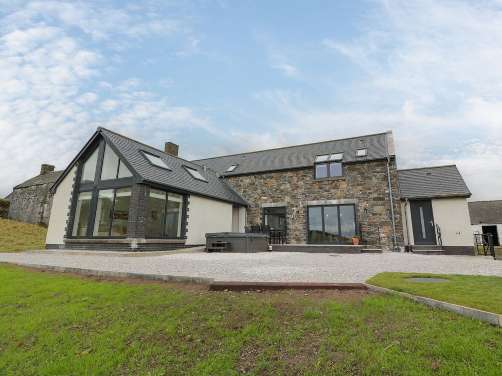 A modern house with stone and glass features at Balcarry Barn near Glenluce
