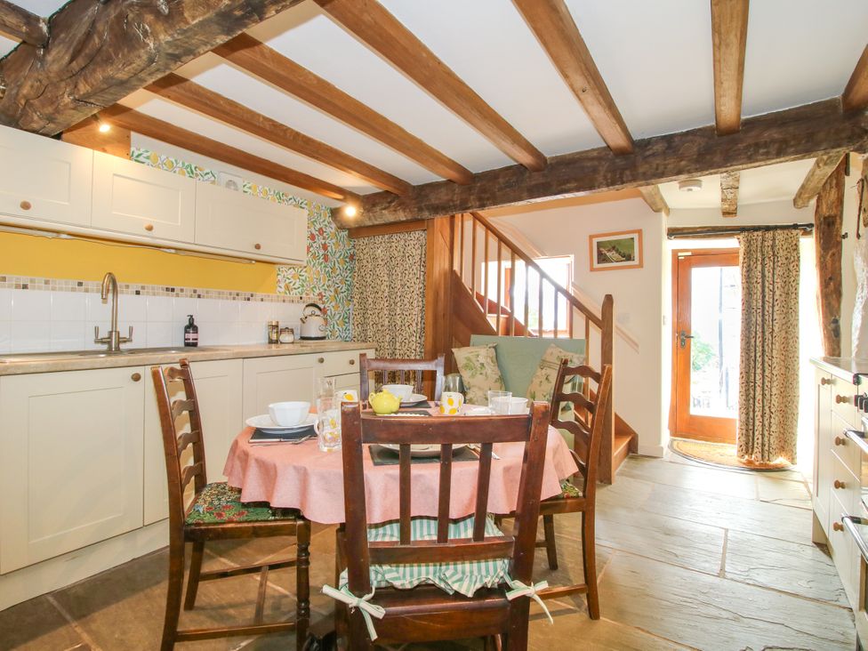 A kitchen with a dining table and chairs at The Long House Near Trefonen