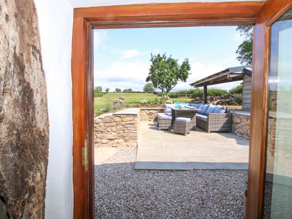 An outdoor area with seating and a table at The Long House near Trefonen