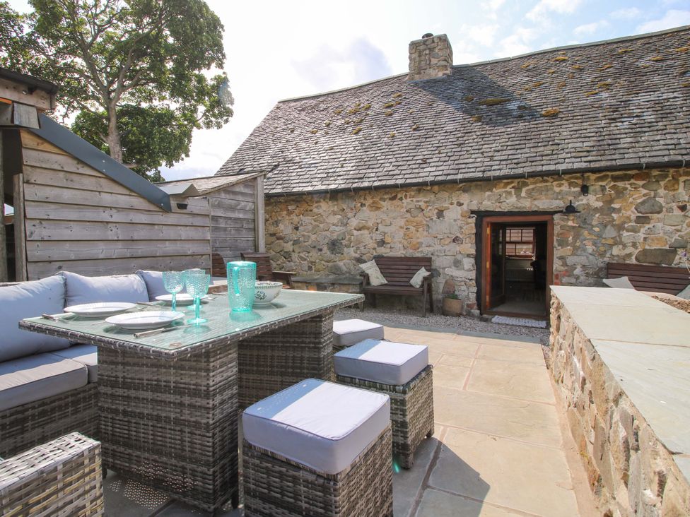 An outdoor area with seating and a table at The Long House Near Trefonen