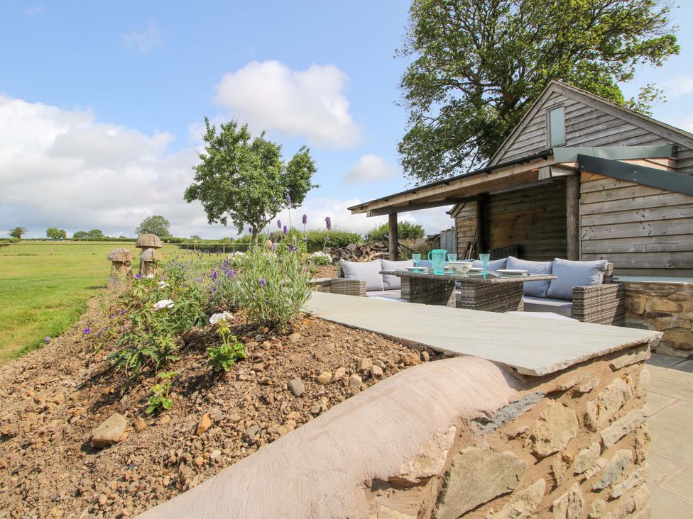 An outdoor area with a seating arrangement at The Long House Near Trefonen
