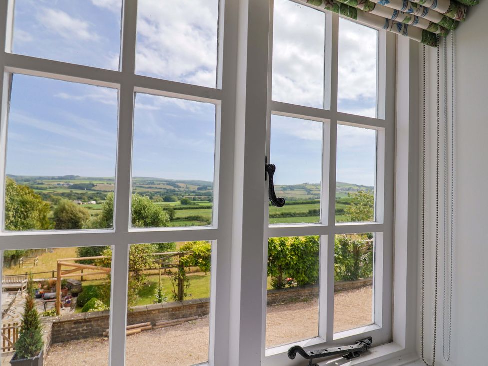 A window view of countryside at Tithe Barn Cottage in Litton Cheney near Burton Bradstock