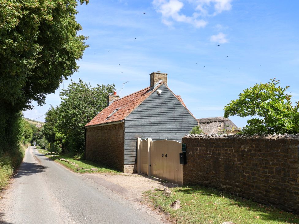A house with a gate on a road at Tithe Barn Cottage Litton Cheney near Burton Bradstock