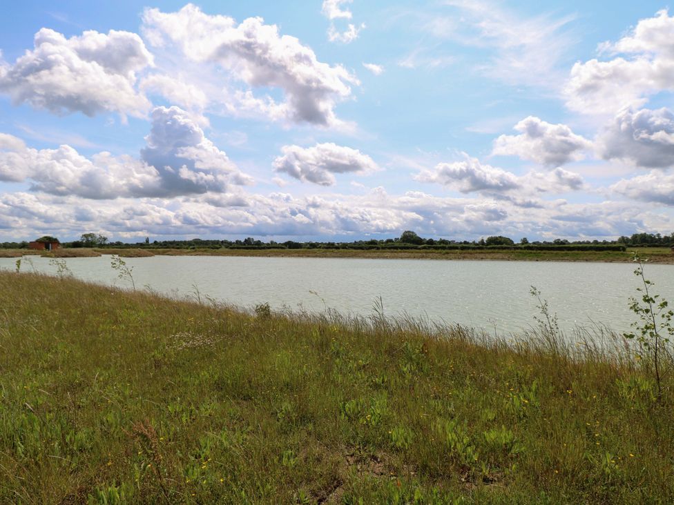 A landscape with water and grass at Oak Tree Holiday Lodge in Stonham Aspal