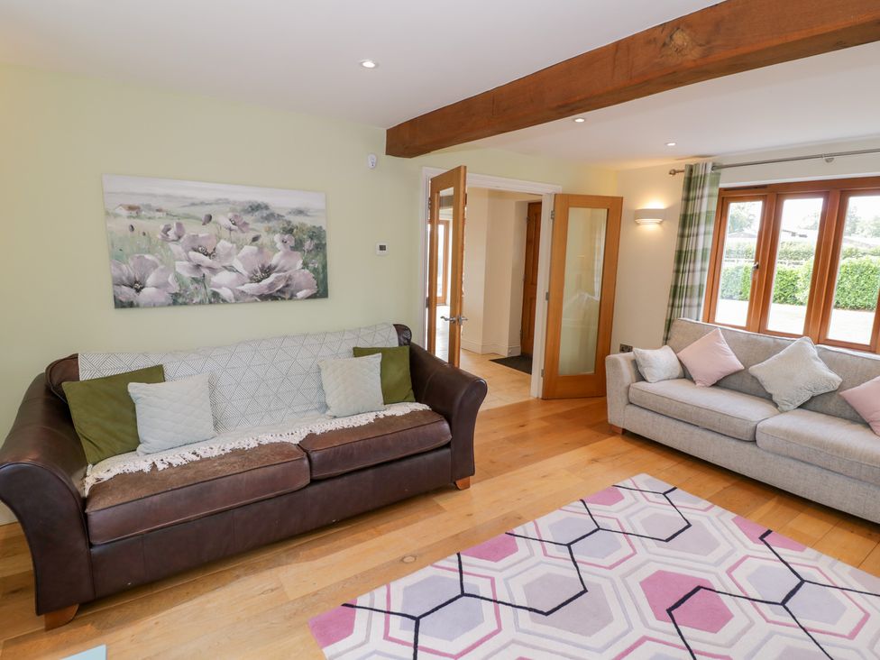 A living room with a sofa and rug at Filly Brook in Bishop's Frome